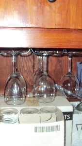 using the buffet built ins for the modern age, wine glass storage on top and more glasses in boxes.